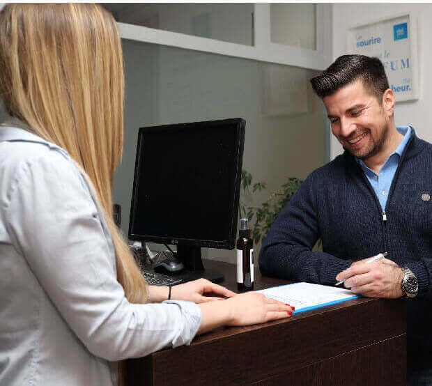 Neutral, unbranded reception desk with a patient checking in